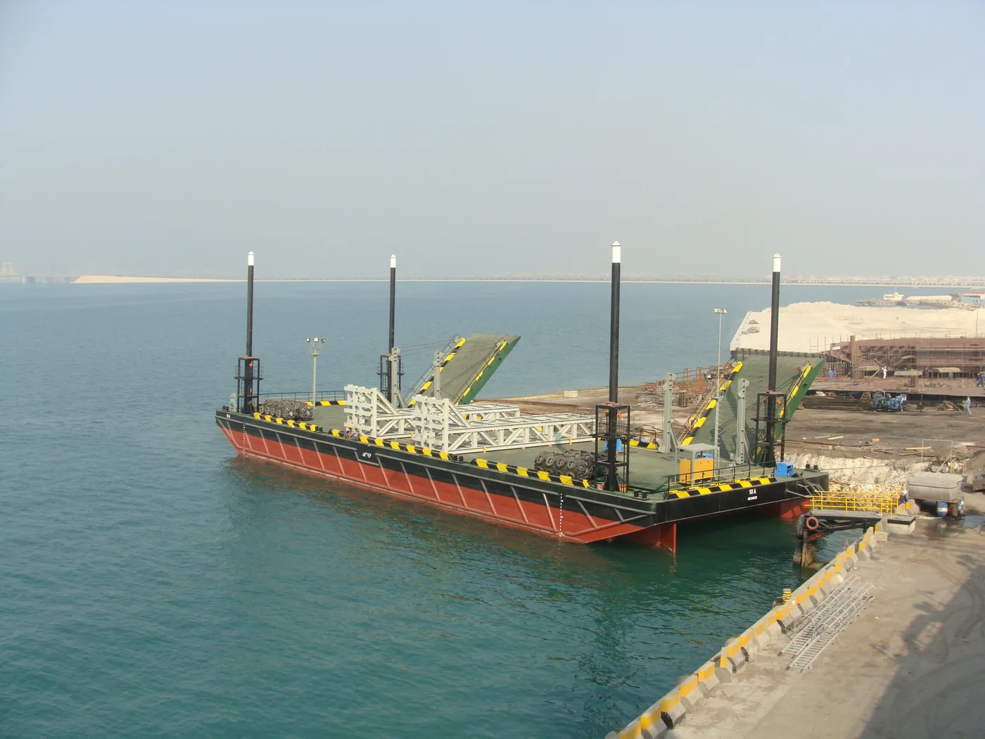 NASS 180 foot class barge alongside the Al Hidd quay
